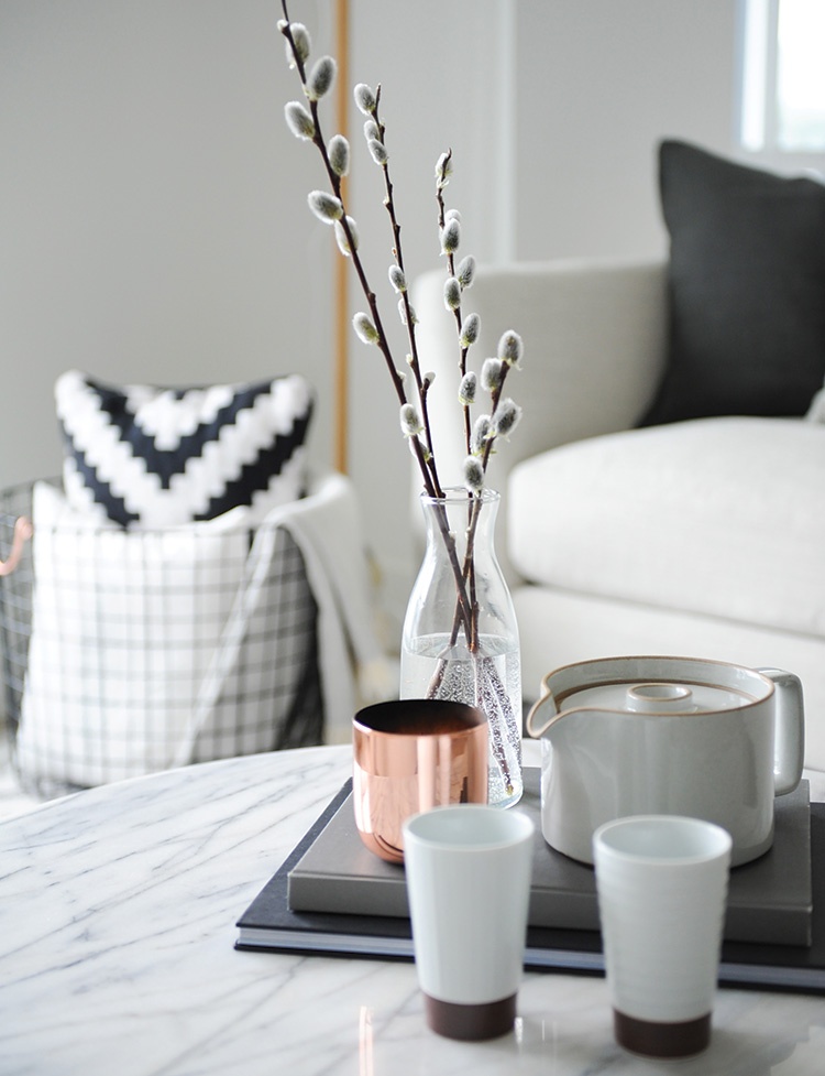 Contrasting accents such as pussy willow branches and a chic copper cup bring the design to life.
