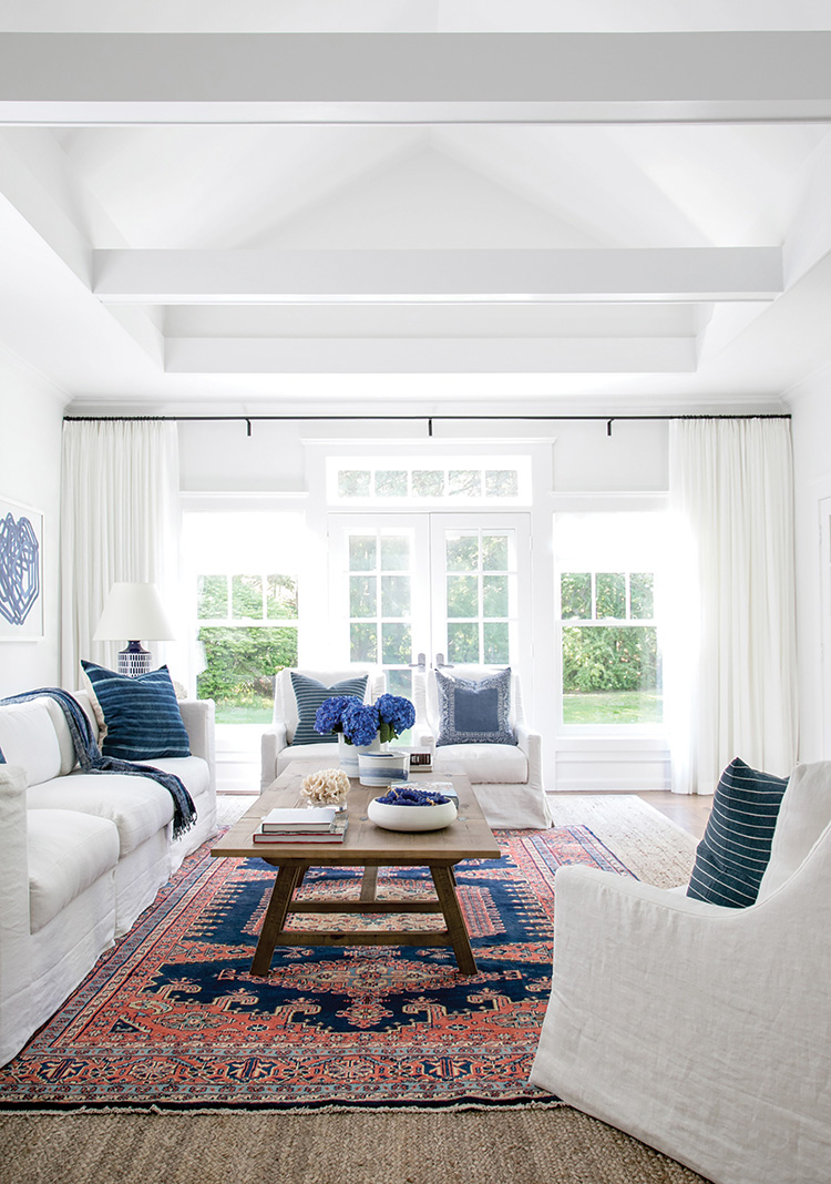 Light floods this house with inviting warmth. Simonpietri’s decision to paint the interior a crisp white enhanced the glow while allowing the deeper blues and reds of the design to pop.