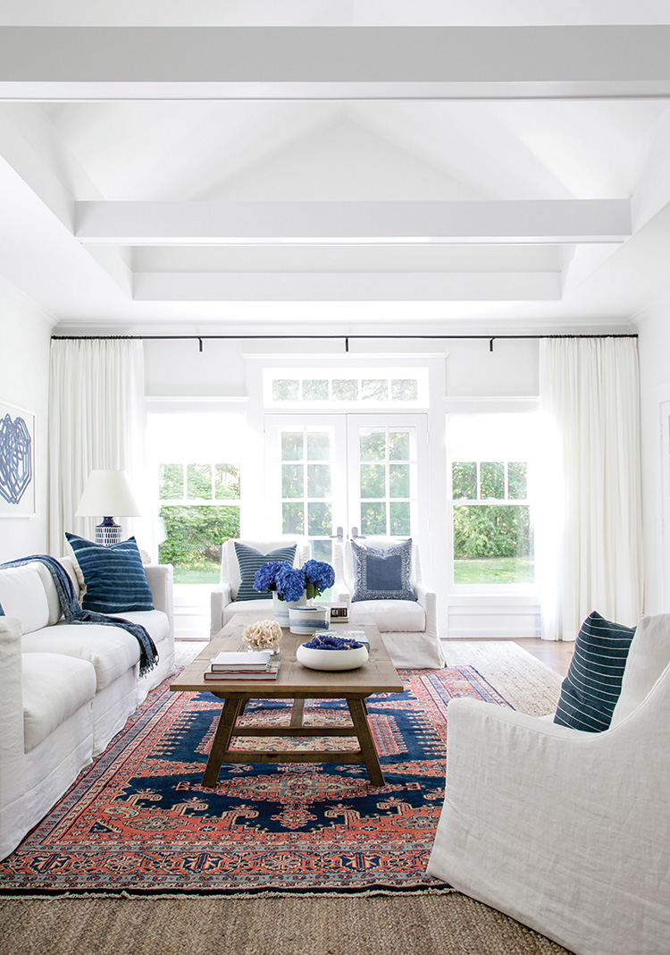 main Light floods this house with inviting warmth. Simonpietri’s decision to paint the interior a crisp white enhanced the glow while allowing the deeper blues and reds of the design to pop.